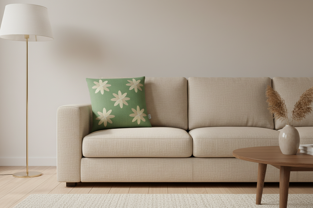 Green daisy cushion on beige sofa